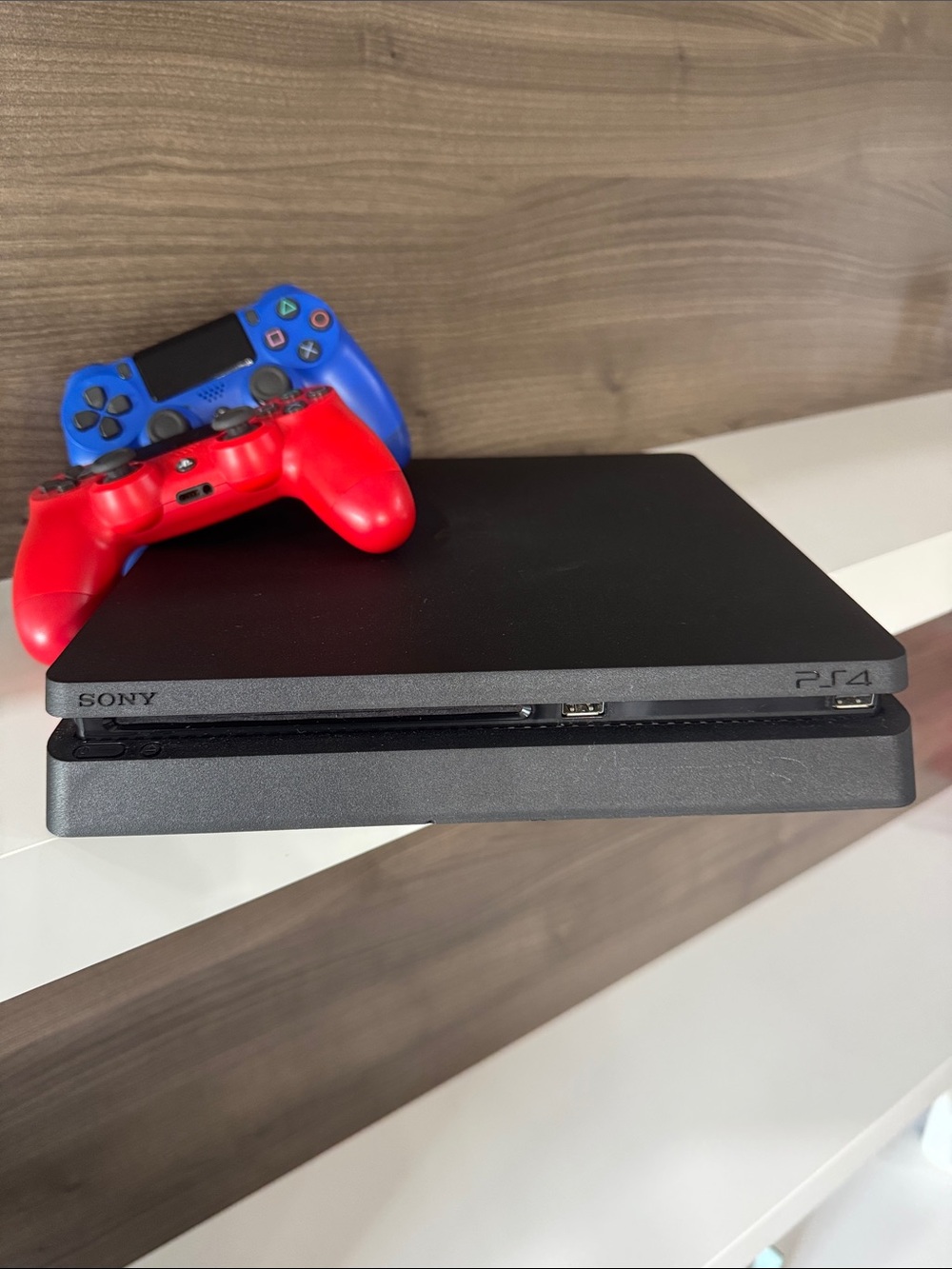 Sony PS4 Slim Console with Red and Blue DualShock Controllers